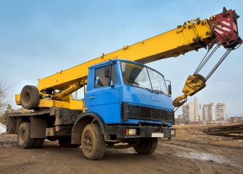 Mobile Crane on a road and tower crane in construction site