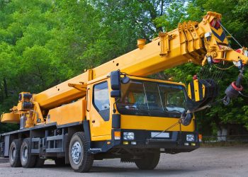 Mobile Crane on a road and tower crane in construction site